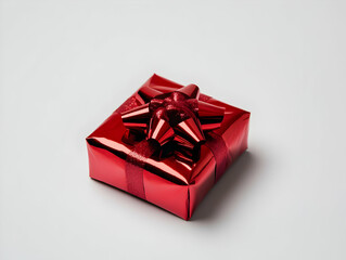 Shiny red gift box with a decorative bow, isolated on a white background.