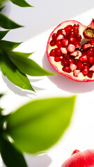 Canvas Print - Pomegranate Seeds and Green Leaves on White Background