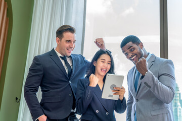 Multiracial Business Team Having a Discussion with Tablets in Modern Office