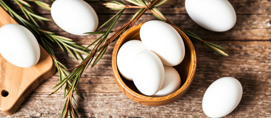 Wall Mural - White eggs in a wooden bowl on a rustic table