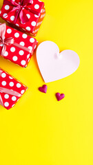 Poster - Polka Dot Gift Boxes and a Heart on Yellow Background