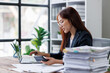 © David - Business financing accounting banking concept. Business woman hand doing finances and calculate on desk about cost at home office. Woman working on desk with using calculator, finance accounting.