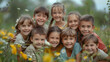© SS Digital - Kids having fun outdoors in summer. Group portrait of happy little school children in the park. Bunch of cheerful friends posing for a group photo, hugging, looking at the camera