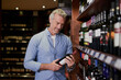 © Sanc/peopleimages.com - Wine, cellar and mature man with bottle for choice, option and decision for vintage collection. Winery, vineyard service and person with label of drink, alcoholic beverage and products for quality