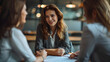 © SS Digital - Portrait of young confident business woman sitting on workplace and signing a contract at office. Group of three coworkers and company employees make a good deal reaching agreement