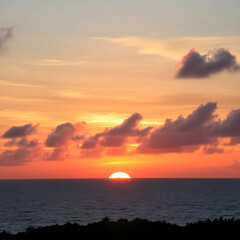 Beautiful shot of the sunset with colorful clouds above the sea