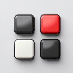 A set of four black and white and red buttons on a gray surface