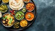 © ALIS ST - A complete Indian thali meal with various dishes and pickles, top view, and ample copy space