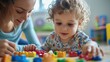 © kimly - a young child learning from a parent, with educational materials and playful interaction.