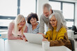 © Halfpoint - Group of senior students looking at tablet screen, learning new skill. Elderly people attending computer and technology education class. Digital literacy.