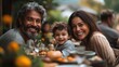 © Wiseman - happy biracial family with small son during family dinner with grandparents outdoors in garden