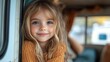 © Wiseman - happy small girl looking out through caravan window, looking at camer family holiday trip