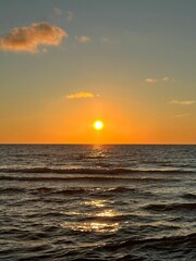 Wall Mural - Sunset over the ocean with gentle waves.