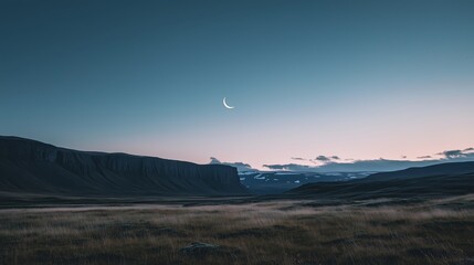Wall Mural - a crescent moon illuminates the serene landscape at dusk in iceland's rugged terrain