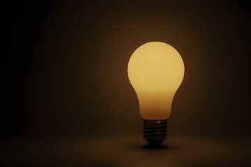 Matte light bulb emitting warm glow on a dark background for creative concepts