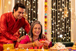 © G-images - Mother with son enjoying diwali at home