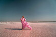 © svetograph - Woman Pink Dress Salt Lake - A woman in a pink dress stands on the shore of a salt lake.