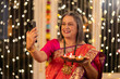 © G-images - Happy senior woman taking selfie on the occasion of festival celebration