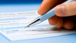 © Eddy Drmwn - A hand fills out a form with a pen.