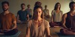 © vefimov - People in a yoga class meditating together, focusing on breath and relaxation.