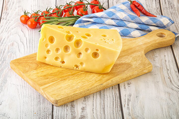 Wall Mural - Maasdam cheese piece over board