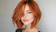 © ЮРИЙ ПОЗДНИКОВ - Beautiful woman with vibrant red hair posing on gray background