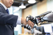 © Angela - Close-Up of Human and Robotic Handshake Representing AI and Business Collaboration