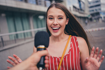 Wall Mural - Photo of cute girl giving interview to journalist speaking in microphone newscast broadcast outdoors