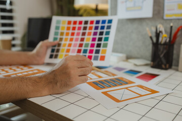 Wall Mural - a web designer is using his idea to create a digital product design project that will meet the needs