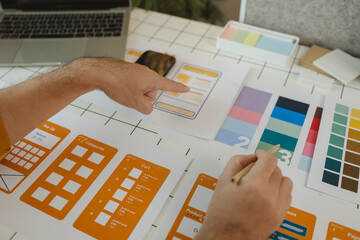 Wall Mural - a web designer is using his idea to create a digital product design project that will meet the needs