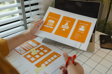 Wall Mural - a digital product developer is working on a plan to work with research data to guide the development
