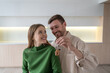 © DimaBerlin - Family happily embraces with keys with house in hand after moving into new apartment. Couple look at each other, feels joy of homeownership, thinking about mortgage, rental savings future in new space