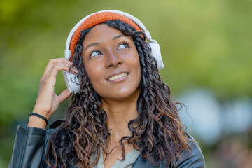 young woman or young girl with headphones outdoors