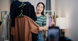 © Johnstocker - Portrait of Cheerful woman influencer is live streaming sell clothes on social media or blogging in home studio. Remote buying, Online shopping, Sell ​​products online