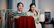 © Johnstocker - Portrait of Two cheerful woman influencers are live streaming sell clothes on social media or blogging in home studio. Remote buying, Online shopping, Sell ​​products online