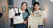 © Johnstocker - Portrait of Two cheerful woman influencers are live streaming sell clothes on social media or blogging in home studio. Remote buying, Online shopping, Sell ​​products online