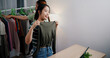 © Johnstocker - High angle view, Two cheerful woman influencers are live streaming sell clothes on social media or blogging in home studio. Remote buying, Online shopping, Sell ​​products online