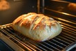 © Yeivaz - A Freshly Baked, Golden Brown Loaf of Bread is Gently Rising in the Oven Right Now