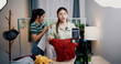 © Johnstocker - Portrait of Two cheerful woman influencers are live streaming sell clothes on social media or blogging in home studio. Remote buying, Online shopping, Sell ​​products online