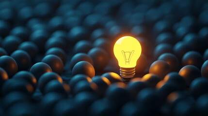 One glowing light bulb standing out from the crowd of many others on a dark background