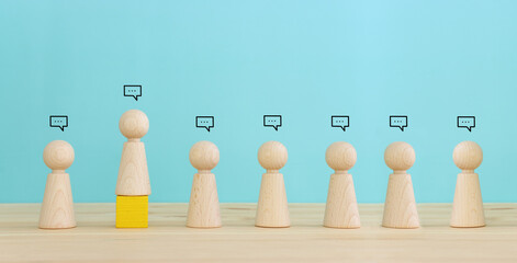 Concept image of wooden figures and bubble speeches icons. Concept of society, teamwork, and communication