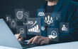 © Supatman - Analyzing ROI and Business Strategy Concepts. Businessman working on a laptop with various digital icons representing ROI, financial strategies, return on investment, and efficiency. marketing plan,