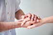 © anatoliy_gleb - Close up of two hands engaging in delicate touch. Man's and woman's hands on white neutral background. Husband holding hand of his lovely wife. Concept of love, intimacy, support, and trust.