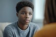 © Pixel Hues - Close-up of black adolescent on therapy session with psychologist, Generative AI