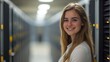 © CinimaticWorks - portrait of a smiling professional young female IT network administrator standing in a server room, embodying confidence and expertise in network management
