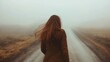 © CinimaticWorks - back view of a woman walking down a foggy rural road, with long flowing hair, capturing the essence of wanderlust, solitude, and adventure on her journey through nature