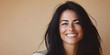 © john - Beautiful middle-aged woman with long dark hair smiling against a beige pastel background