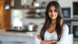 © CinimaticWorks - Indian woman standing in a modern kitchen with a soft blurry background highlighting her culinary skills and the inviting atmosphere of her home