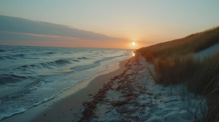 Canvas Print - The beach is calm and peaceful with the sun setting in the background