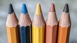 © Kukar Studio - Close-up of a row of colorful pencils arranged in a vibrant pattern, highlighting the textured surface and sharp points of each pencil